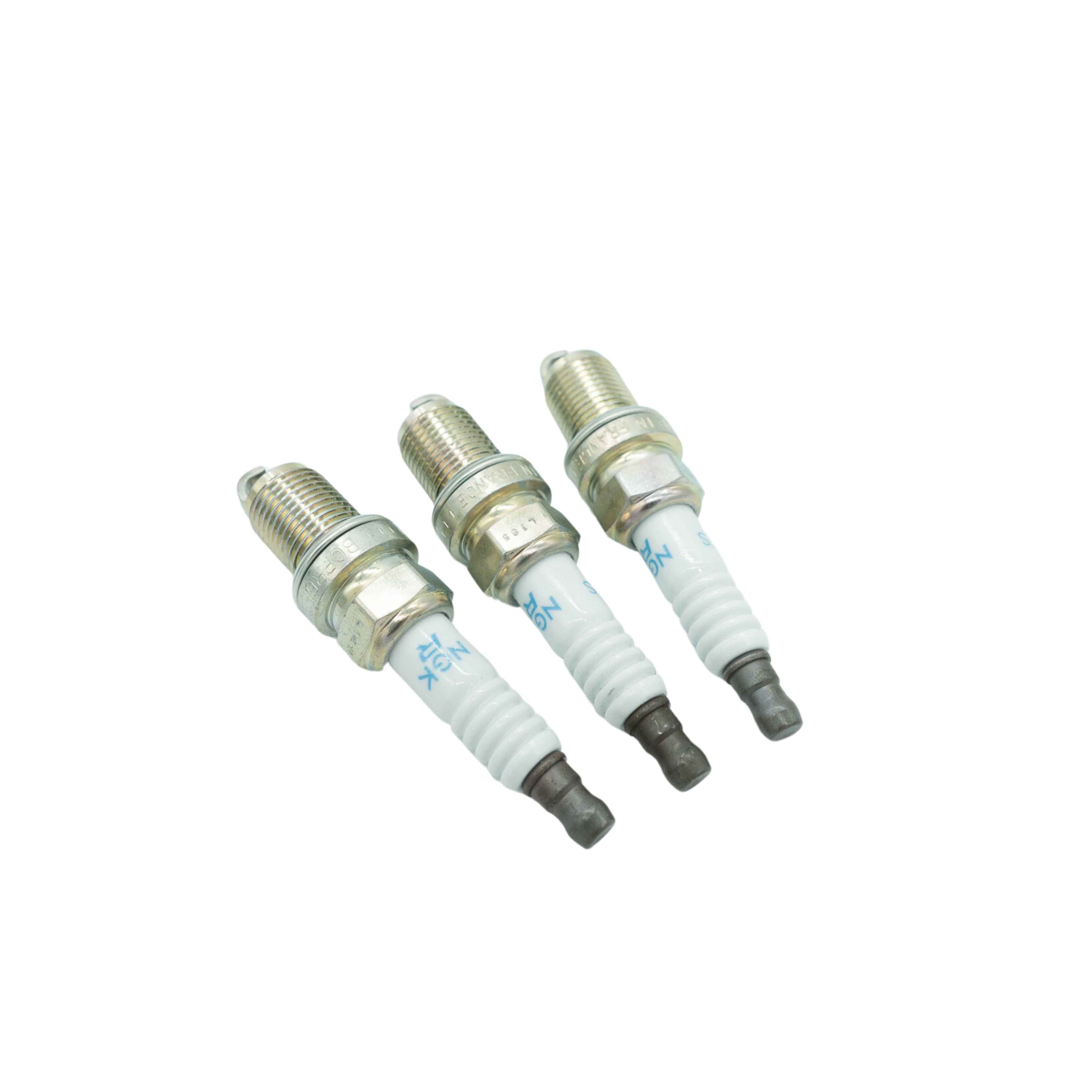 Set of three pristine spark plugs for Honda Acty HH3 HH4 series from 1990-1999, displayed at an angle to showcase brand markings and ceramic insulation, essential for engine maintenance
