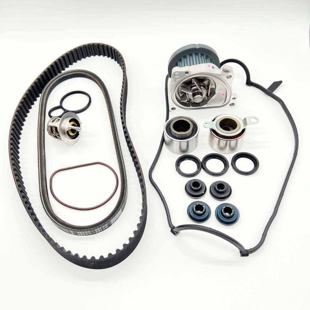 Honda Acty HH3 HH4 9-Piece Timing Belt Kit, featuring a ribbed belt, water pump, thermostat, tensioner and idler pulleys, cam and crank seals, and valve cover gasket, designed for 1990-1999 models.