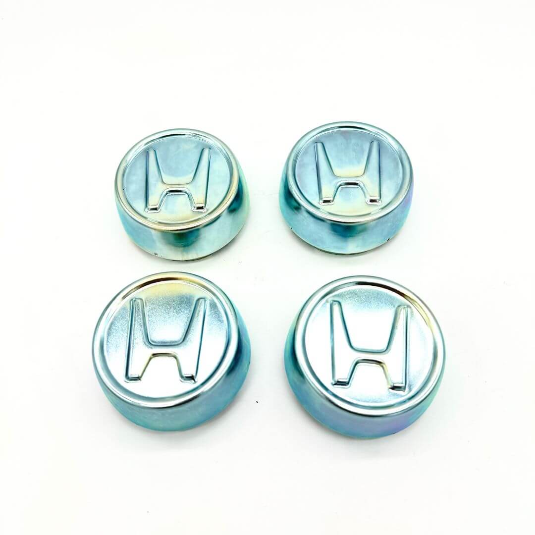 Honda Acty Van Wheel Center Cap Set (1990-1999): Durable metal caps designed to fit securely onto HH3 and HH4 model wheels, adding a sleek aesthetic and brand recognition with a polished 'H' logo on each cap.