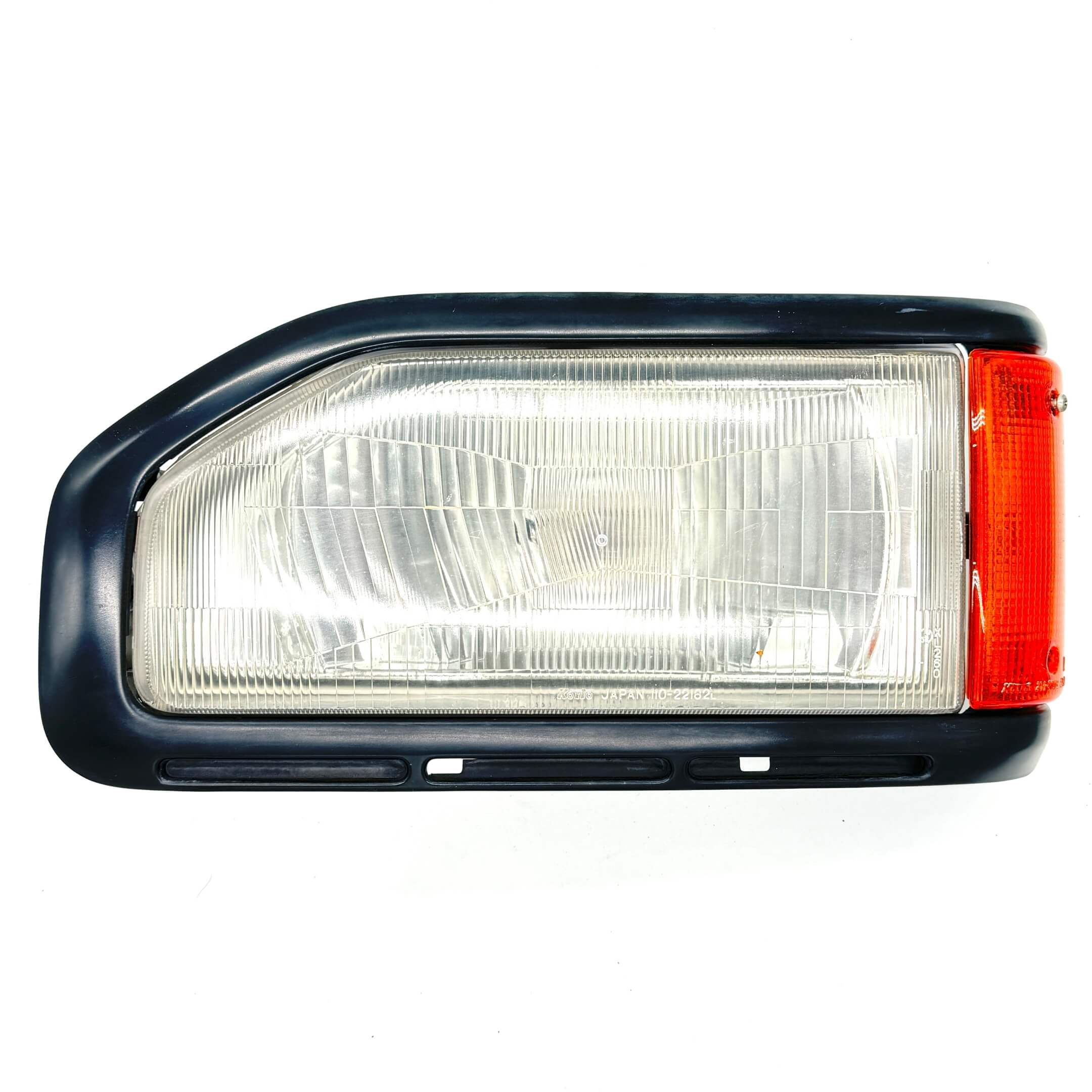 Side view of Left Headlight Assembly for Honda Acty Van HH3, HH4 models (1990-1993) showing the detailed lens and indicator