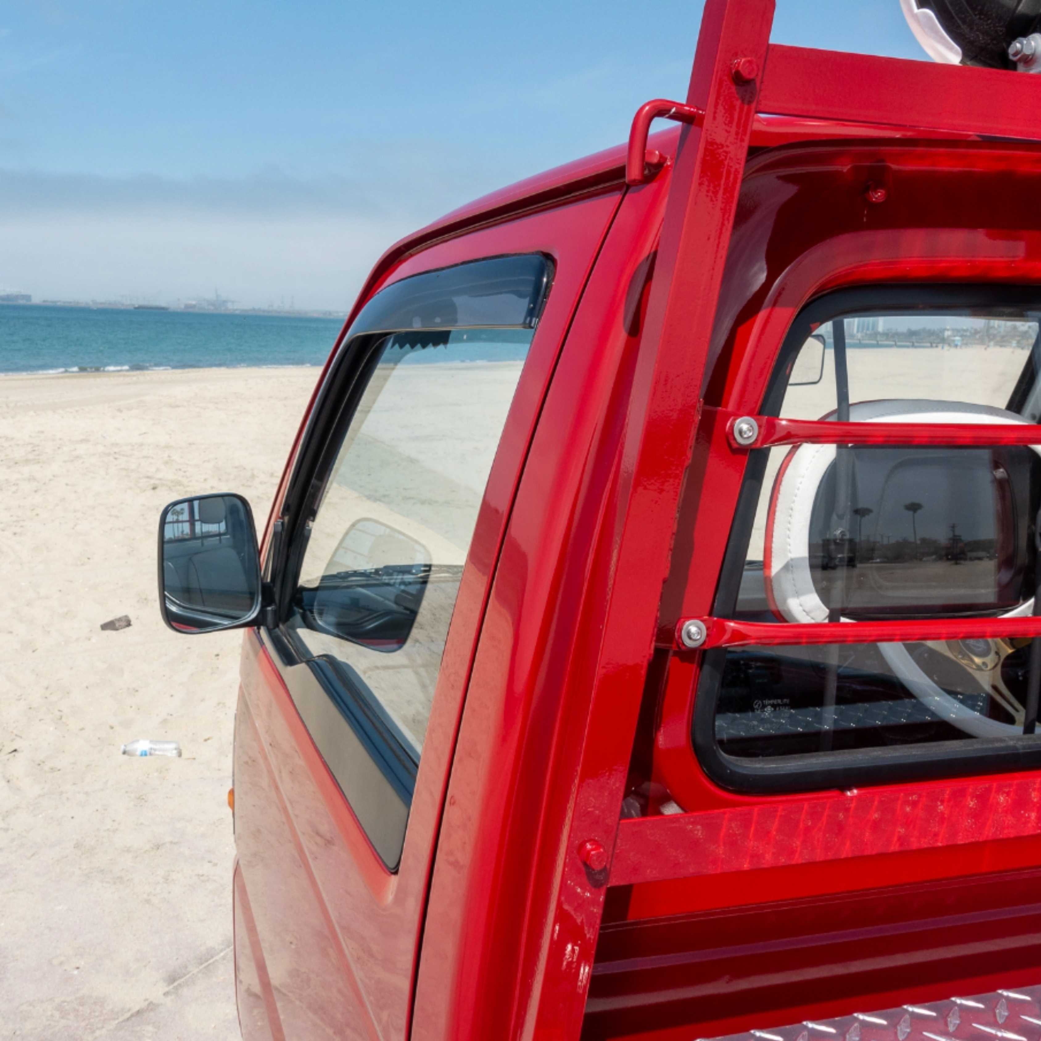 Close-up of rain guard on Honda Acty Van window, providing fresh air flow and rain shield.