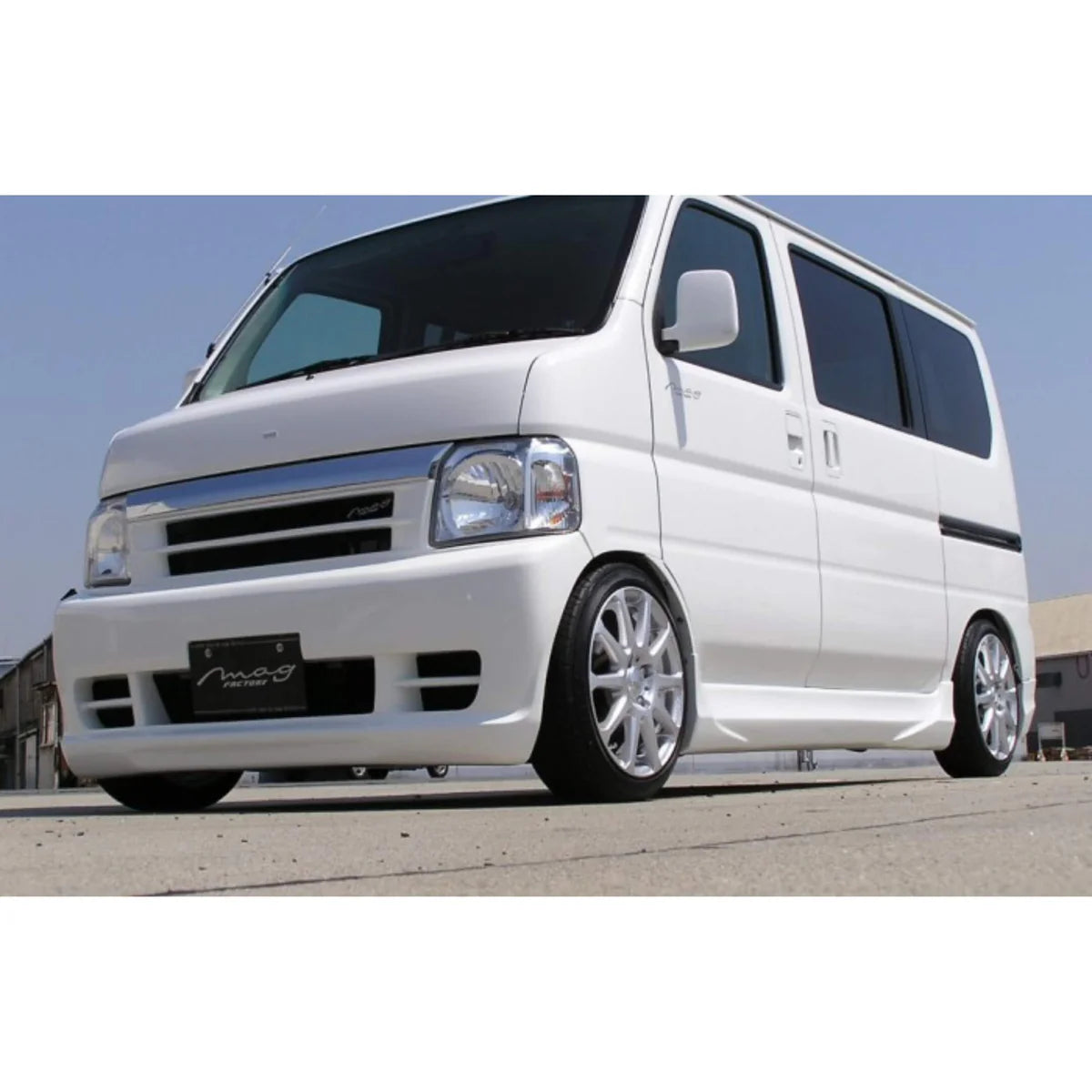 Customized white Honda Vamos kei van featuring lowered stance, alloy wheels, sporty body kit, and Mag Factory styling upgrades, ideal for urban enthusiasts.