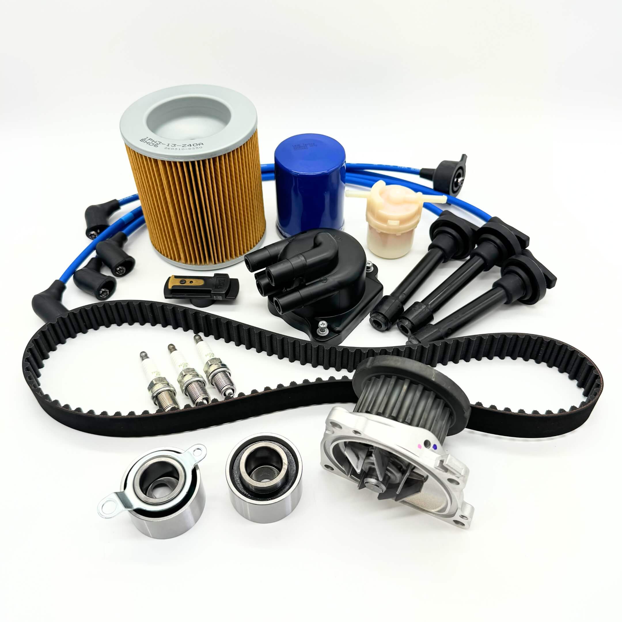 14-piece Mega Timing Belt and Tune-Up Kit for Honda Acty HH3/HH4 1990-1999, featuring an air filter, fuel filter, oil filter, distributor cap and rotor, spark plugs and wires, and a premium timing belt, all displayed on a white background, available with free shipping from Oiwa Garage.