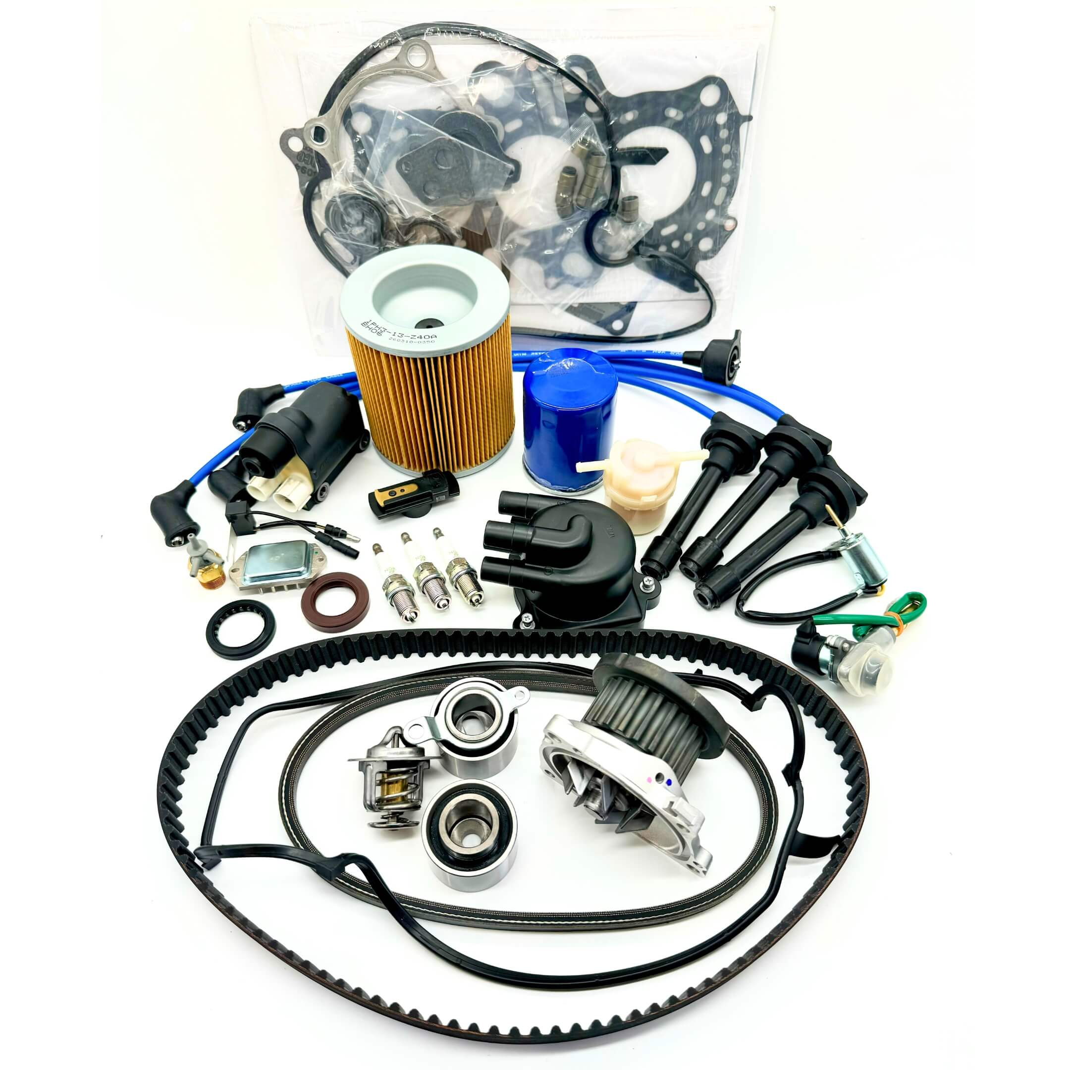 23-piece Mega Timing Belt and Tune-Up Kit for 1997 Honda Acty HA3/HA4 showcased on a white background, including high-quality air and fuel filters, oil filter, distributor cap and rotor, spark plugs with wires, ignition control module with coil sensor, ignition assembly, complete engine gasket set, timing and alternator belts, and air thermal valve, available at Oiwa Garage with free shipping, ideal for vehicle maintenance and engine optimization.
